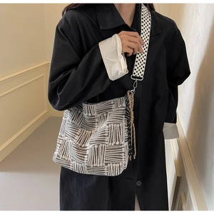 Detail of large canvas tote bag with abstract striped pattern and wide shoulder strap
