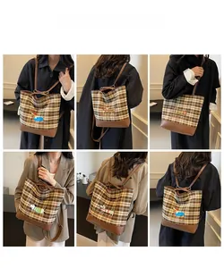 Multiple views of a retro plaid crossbody bag with sausage dog embroidery on a model