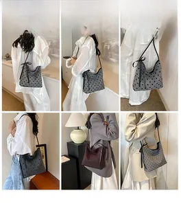 Polka dot canvas shoulder bag with decorative ribbon bows shown in various carrying styles