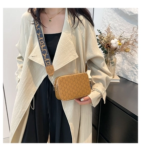 Detail of vintage caramel monogram crossbody bag with wide strap and gold hardware
