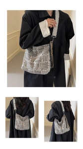 Detail of grey striped canvas tote with black and white geometric pattern shoulder strap