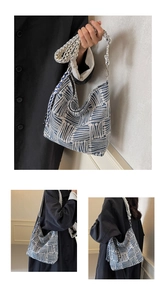 Close-up of geometric pattern canvas hobo bag with wide shoulder strap and metal buckle