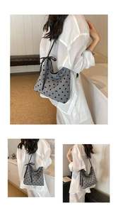 Detail of grey bucket bag featuring black polka dots and decorative ribbon bow accents