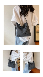 Close-up of a dark grey polka dot bucket bag with ribbon bow and drawstring details