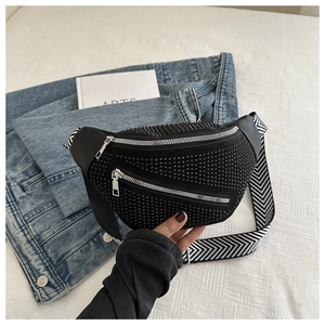 Detail of luxury black rhinestone fanny pack with stylish chevron pattern strap and silver zip
