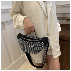 Detail of sequin rhinestone waist bag with pearl zipper and chevron strap on model