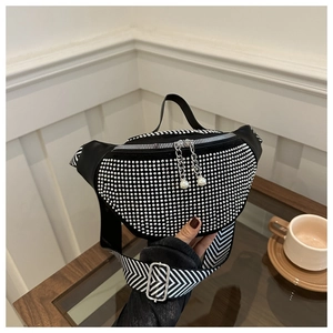 Detail of black belt bag with sparkling rhinestones and geometric pattern wide strap