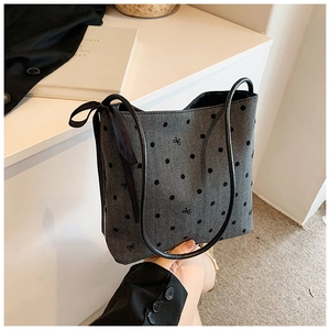 Chic grey polka dot tote bag with black ribbon bow and minimalist bucket style