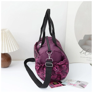 Detail of purple camo travel duffel bag with side drawstring pocket and silver metal zipper