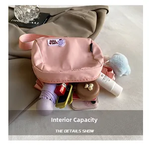 Pink nylon crossbody bag interior capacity showing umbrella, phone and cosmetics