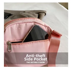 Detail view of pink nylon shoulder bag featuring an anti-theft zipper side pocket