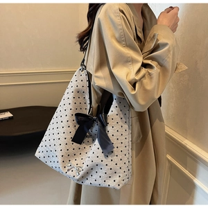 Spacious grey tote bag with heart pattern and large black bow detail for women