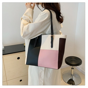 Fashionable color-block patchwork PU leather tote bag shown from a stylish side perspective