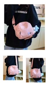 Pink nylon shell bag with purple mushroom patch and star plush pendant detail