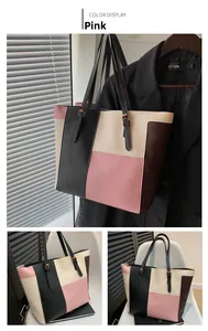Detail view of pink color-block tote bag with four-color leather panels and golden buckles