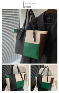 Detail view of large contrast color tote bag with PU leather texture and gold hardware