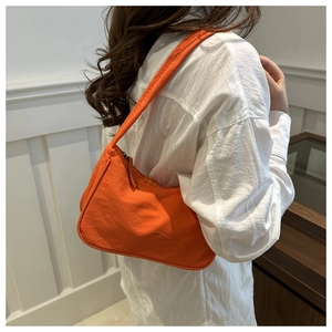 Minimalist bright orange crescent shoulder bag in textured fabric for women