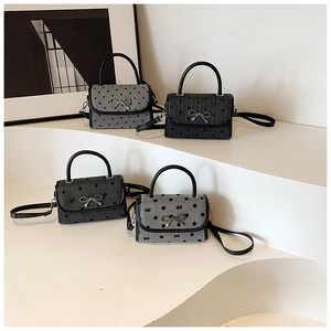 French style mini bow handbags with polka dot and heart patterns in a tiered display