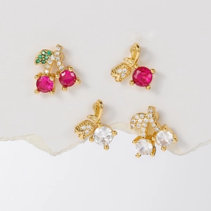 Detailed view of cherry zircon stud earrings with red and white crystal in gold setting
