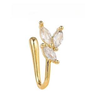 Macro detail of gold U-shaped non-piercing nose ring with marquise-cut zircon stones