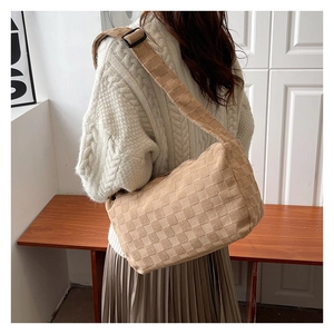 Close-up of beige woven texture bag with adjustable black buckle strap detail