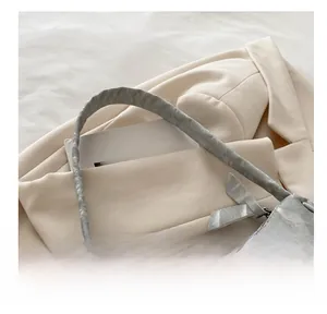 Detailed close-up of marble pattern shoulder bag with silver zipper and soft top handle