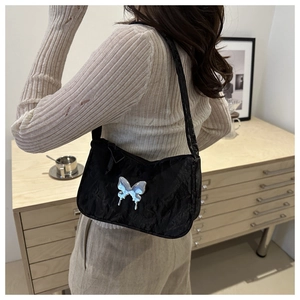 Chic black pleated shoulder bag with a silver butterfly accent for women's fashion