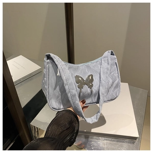 Detail of light blue wrinkled fabric handbag with silver butterfly buckle decoration