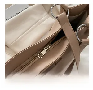 Macro detail of high-quality silver zipper and metal rings on khaki tote bag