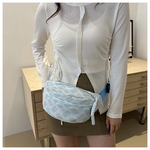 Blue and white checkerboard woven waist bag with a light blue adjustable textile strap