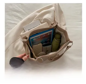Top view of spacious beige tote bag interior showing capacity for tablet and daily items