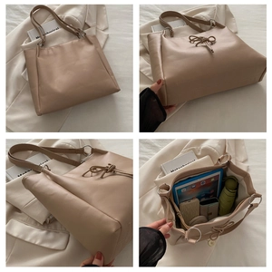 Detailed interior view of beige tote bag showing large capacity for tablets and umbrellas