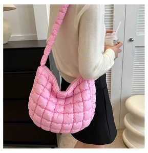 Pink quilted cloud tote bag worn by a model showing the large capacity and puffy texture