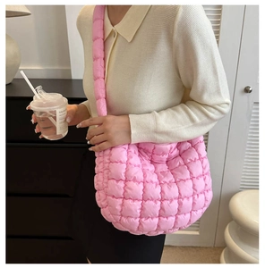 Detailed view of pink quilted cloud tote bag worn on shoulder for casual style