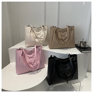 Bow-knot tote bag with braided straps in off-white, khaki, pink, and black colors
