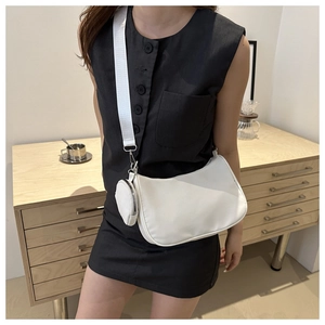 Chic white baguette bag with small coin purse and adjustable wide shoulder strap details