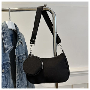 Black nylon hobo bag with a mini round coin purse on a wide shoulder strap