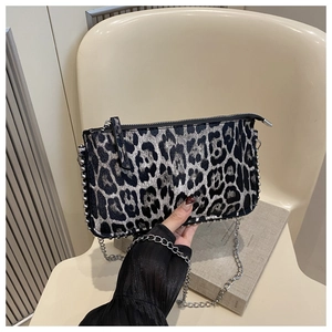 Detail of leopard print shoulder bag with silver rivet trim and metal chain strap