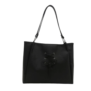 Fashionable black tote bag with ballet-style bow and twisted straps in matte PU leather