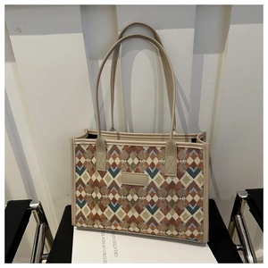 Detailed view of checkered wool tote bag with premium leather handles and trim