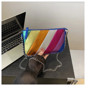 Detailed close-up of rainbow metallic stripe bag with silver rivets and chain strap