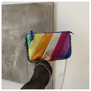 Detailed shot of iridescent rainbow stripes on crossbody bag with metal chain edging