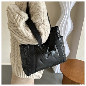 Chic black quilted puffer tote bag in glossy nylon fabric with wide fabric shoulder straps