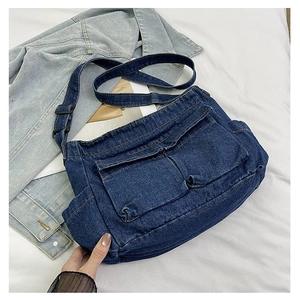 Retro dark blue denim crossbody bag with dual front flap pockets and adjustable strap