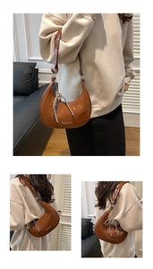 Detail of brown patent leather hobo bag with pearl bow chain and white fashion text