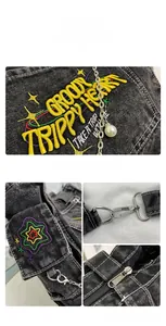Close-up of black washed denim bag featuring yellow Groovy Trippy Heart embroidery and chain