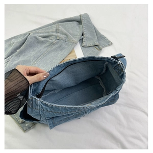 Detail view of large capacity interior with zipper and blue denim lining in tote bag