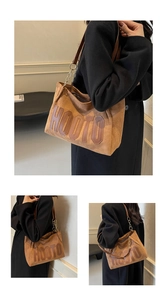 Macro detail of brown suede tote bag with HOOTO leather lettering and chain strap