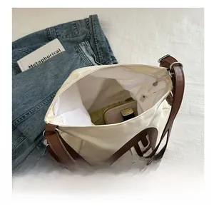 Top view of large canvas tote bag showing spacious interior with leather straps