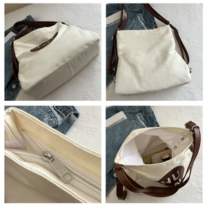 Detail view of large canvas tote bag showing interior space, zipper, and multi-angle design